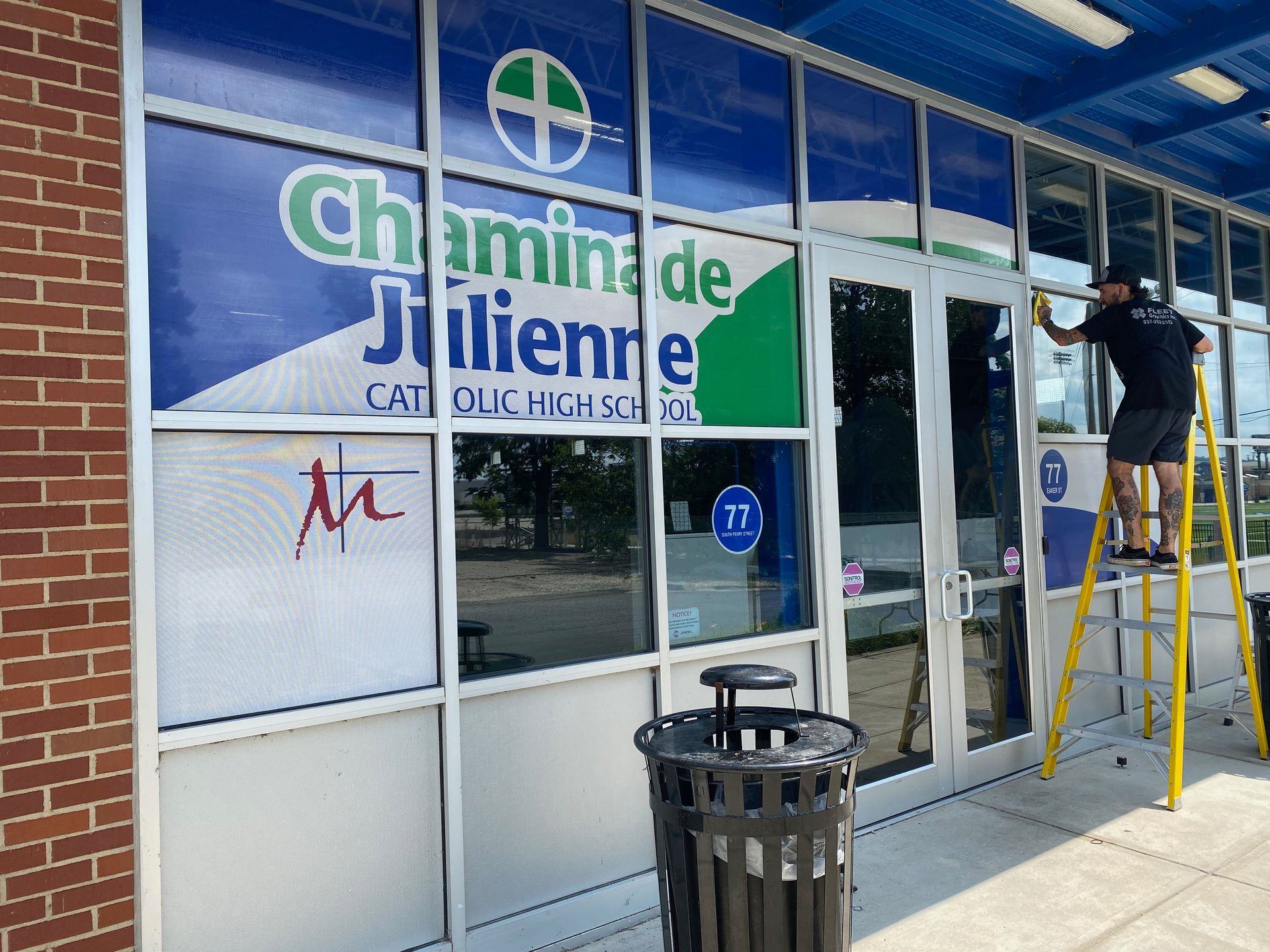 Person cleaning windows of a store with
