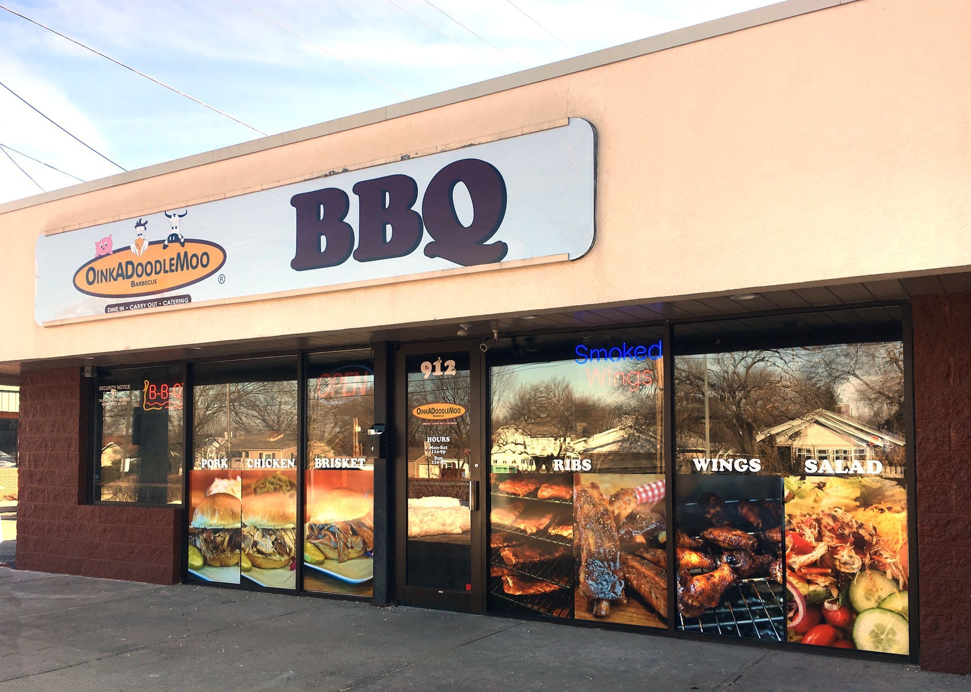 BBQ restaurant storefront with a sign. The sign has