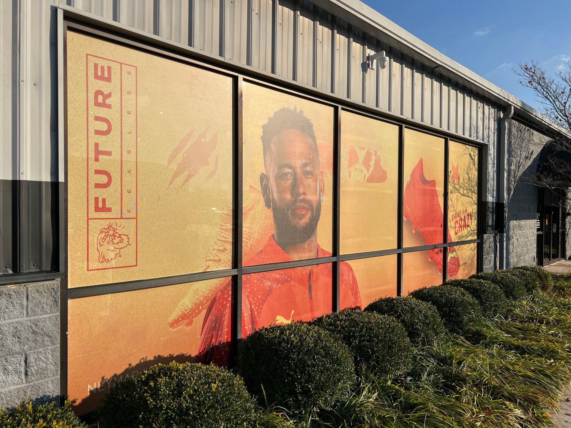 A building with a Neymar advertisement in its windows, featuring the word