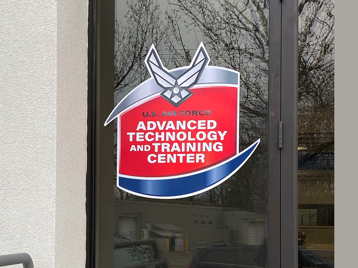 U.S. Air Force Advanced Technology and Training Center sign on a glass door.