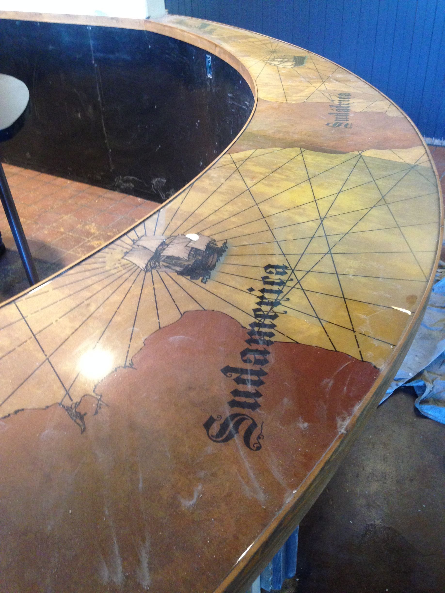Close-up of a wooden bar with a map design,