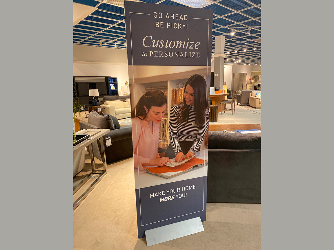 Banner ad: Two women customize a home décor item. Gray and blue tones.