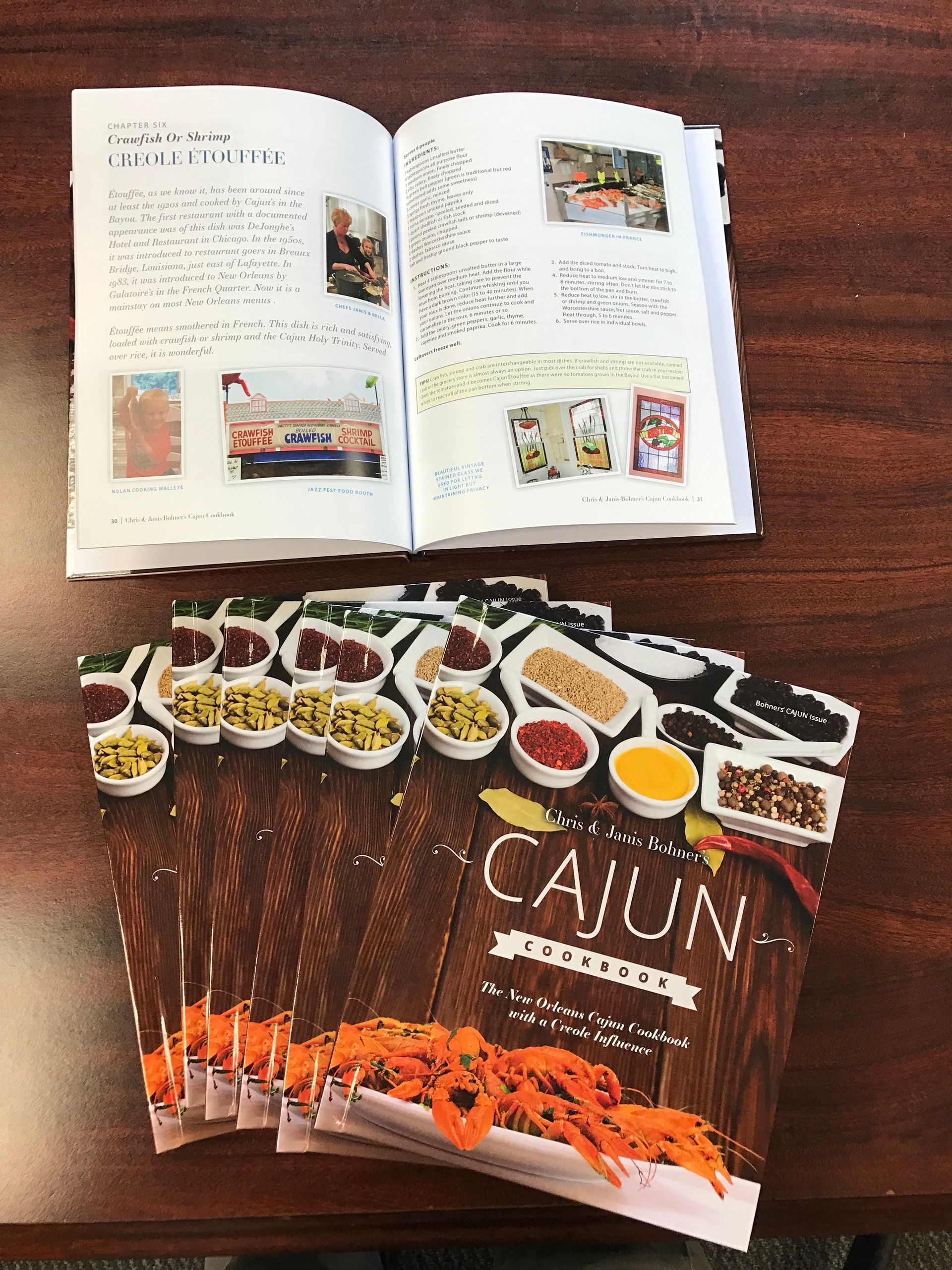 Stack of Cajun recipe brochures with an open brochure on top.