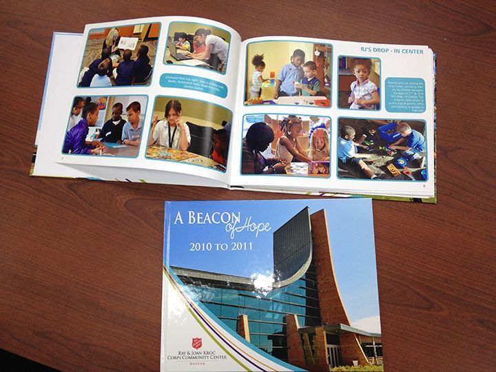 Open book with photos, cover showing a modern building. Title: 