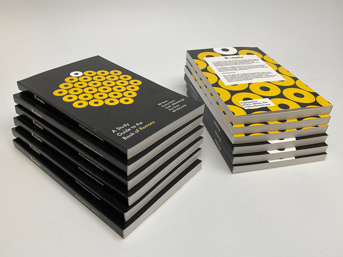 Stacks of books with yellow and black covers, set on a white surface.