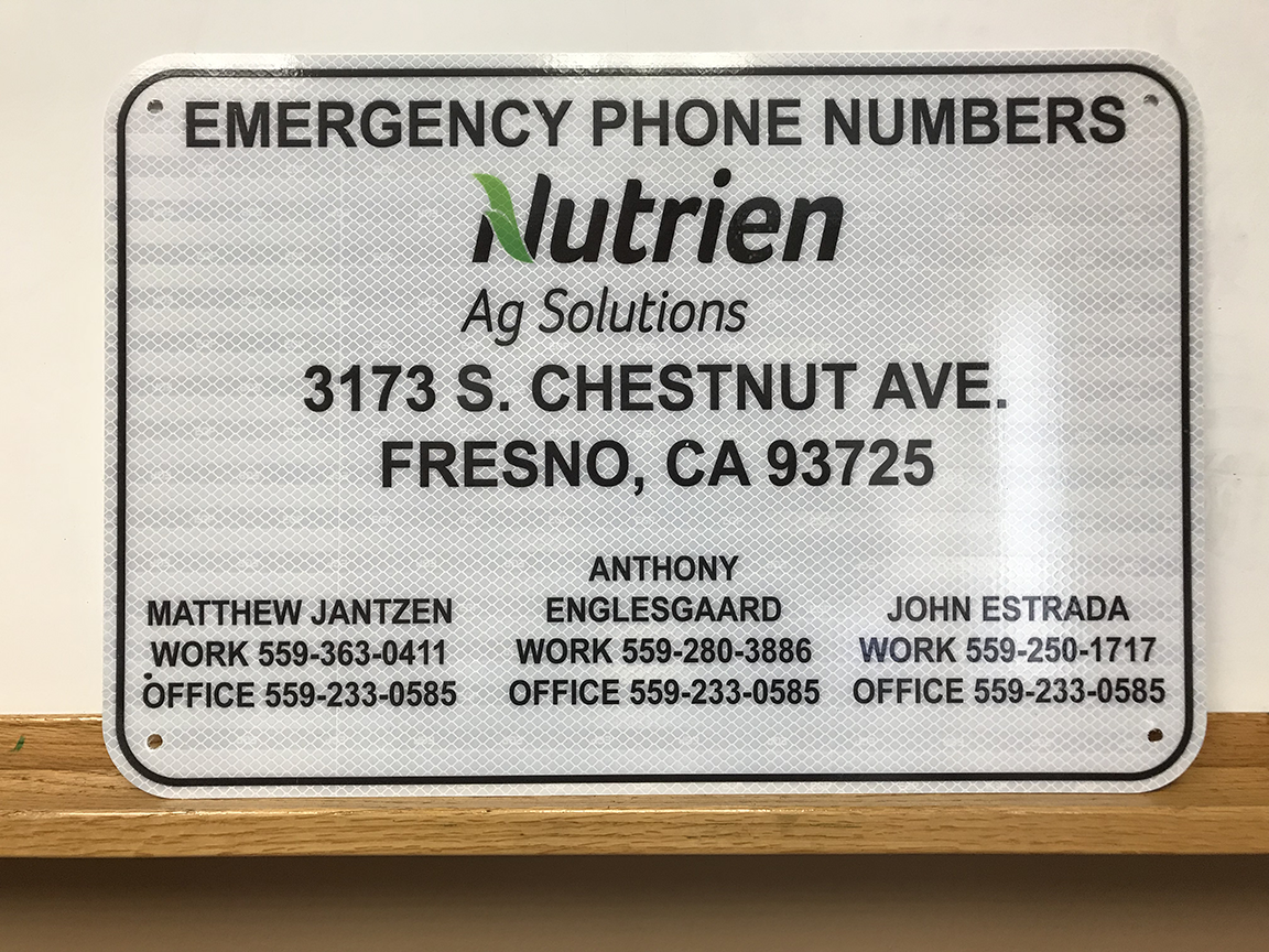 Emergency phone numbers sign for Nutrien Ag Solutions in Fresno, CA, with contact information for Matthew Jantzen, Anthony Englesgaard, and John Estrada.