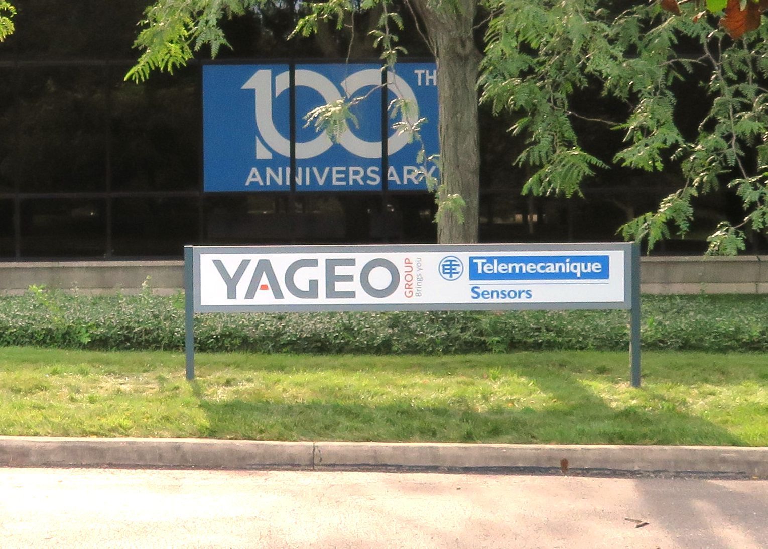 Sign for Yageo and Telemecanique Sensors at a building celebrating a 100th anniversary.