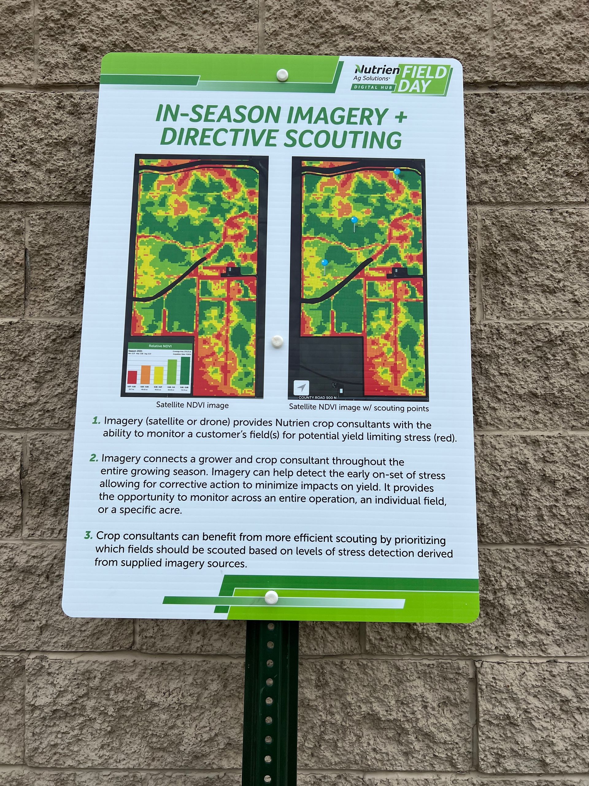 Sign showing two maps of a field, using a color scale, with text about in-season imagery and scouting.