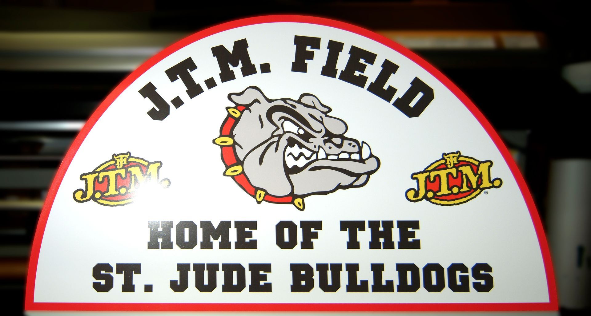 Sign for J.T.M. Field, home of St. Jude Bulldogs. Features bulldog mascot with 