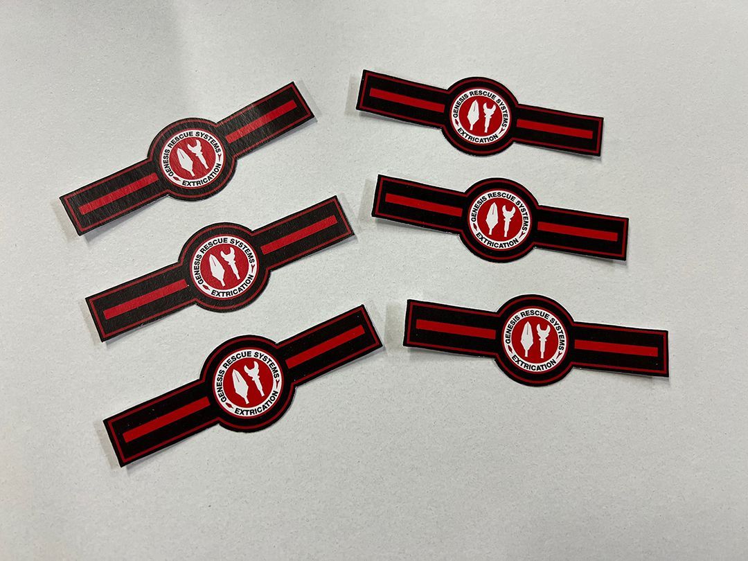 Six cigar bands with red and black stripes, and a circular logo with two white flames.