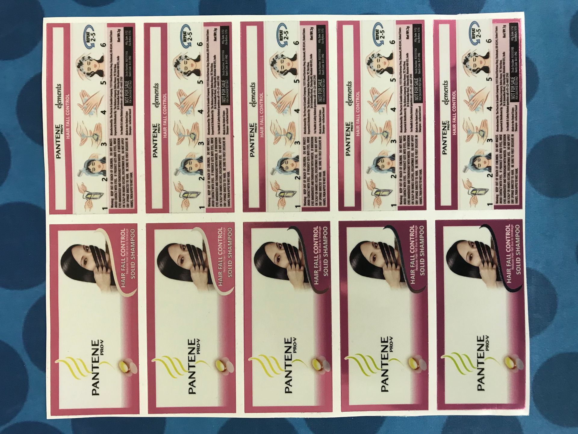 Sheet of printed Pantene labels; pink, white, and black, featuring women's hair and product details.