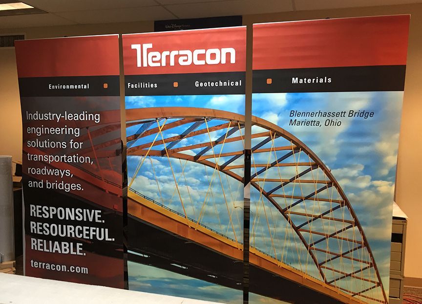 Trade show display for Terracon, showing an arch bridge and company information on a red, blue, and white backdrop.