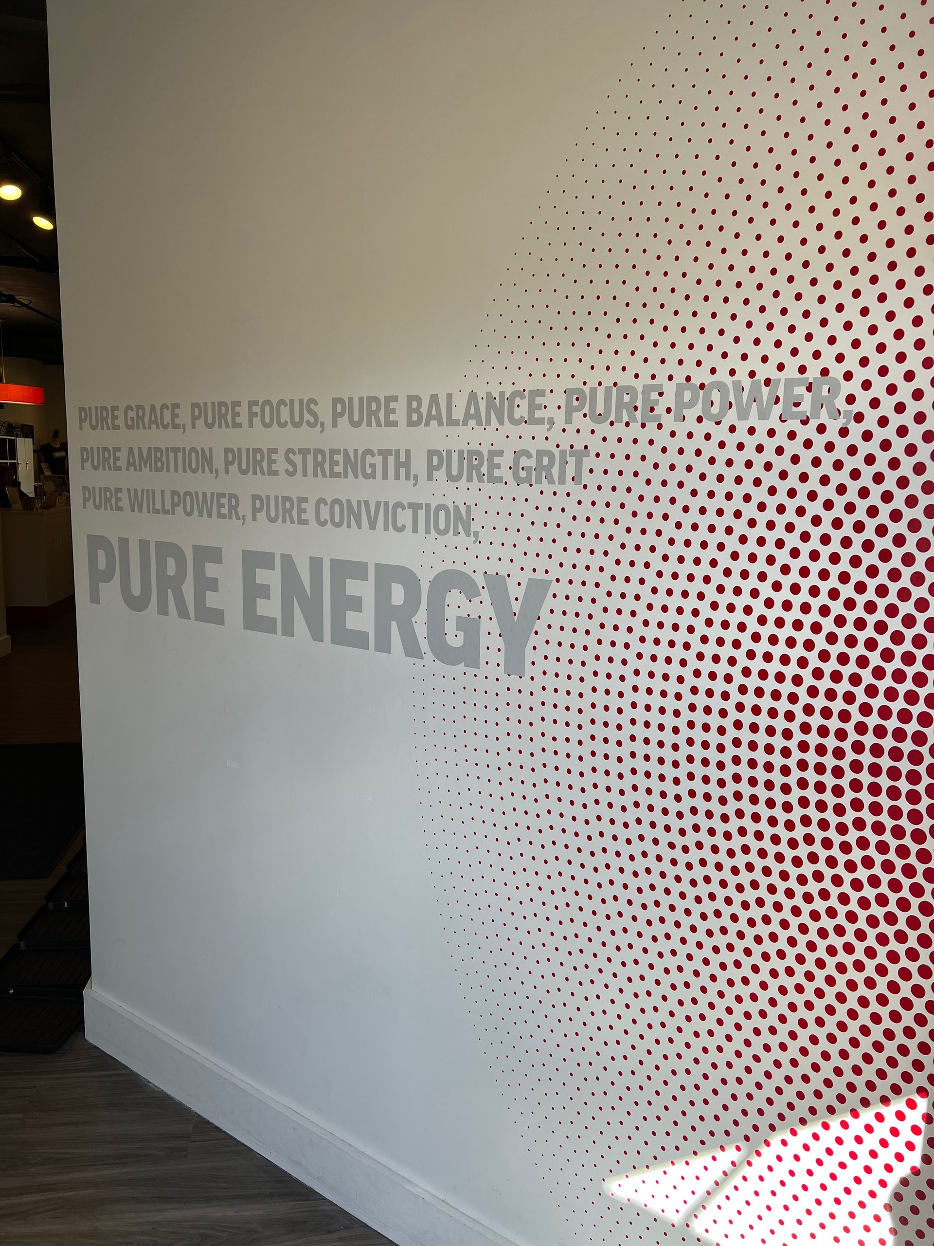 White wall with silver text: