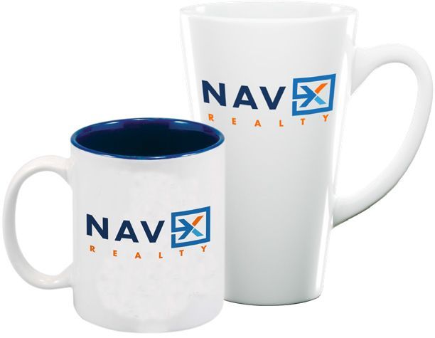 Two white NAV Realty mugs: a standard mug with a blue interior and a tall, tapered mug.