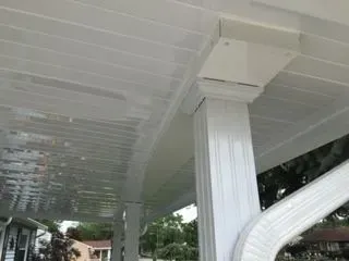 White porch ceiling and column, with gutter and downspout.