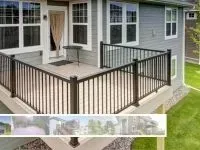 Gray house with a small outdoor deck, black railing, and a small table.