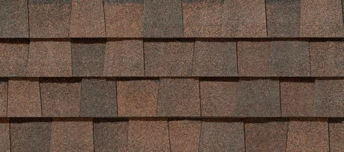 Brown and dark brown asphalt shingles, textured, overlapping pattern.