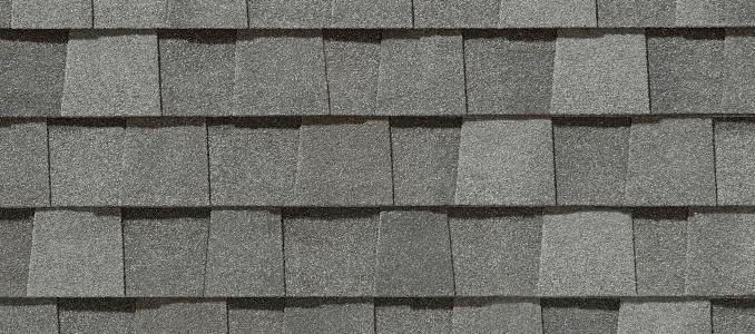 Close-up view of gray asphalt roof shingles arranged in overlapping rows.