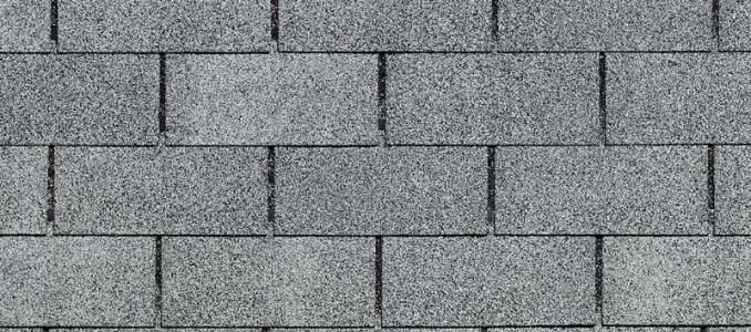 Close-up of gray asphalt roof shingles.