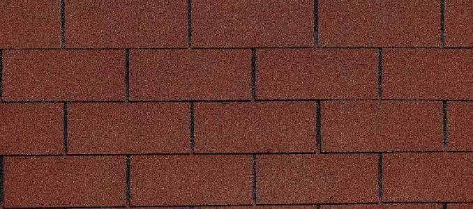 Red asphalt roof shingles arranged in a brick pattern.