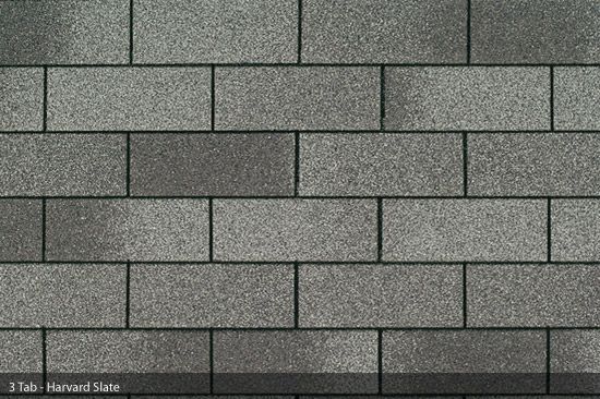 Gray asphalt roof shingles in a brick-like pattern.