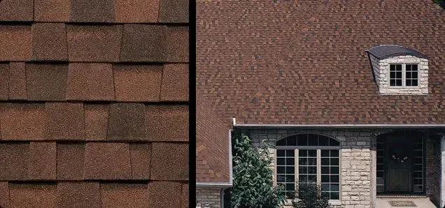 Close-up of brown roof shingles next to a house with a brown shingled roof, a dormer, and a brick facade.