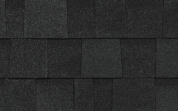 Dark asphalt roof shingles, textured, in a rectangular pattern.
