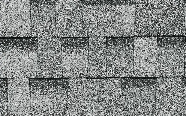 Gray asphalt roof shingles arranged in overlapping rows.