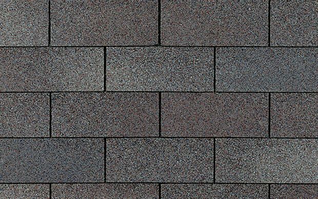 Dark gray asphalt roof shingles in a brickwork pattern.
