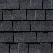 Dark gray asphalt roof shingles in a close-up, overlapping pattern.