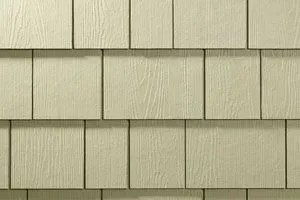 Tan, square-cut siding with wood grain texture, overlapping in rows.
