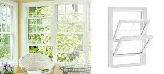 White double-hung window in a bright interior with a view of greenery; isolated image of window opened.