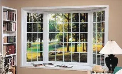 Bay window overlooking a green landscape with trees, flanked by a bookshelf and a lamp.