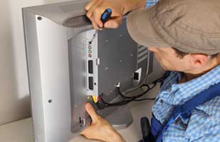 technician repairing television