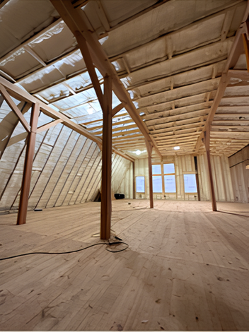 The inside of a building under construction with a wooden floor