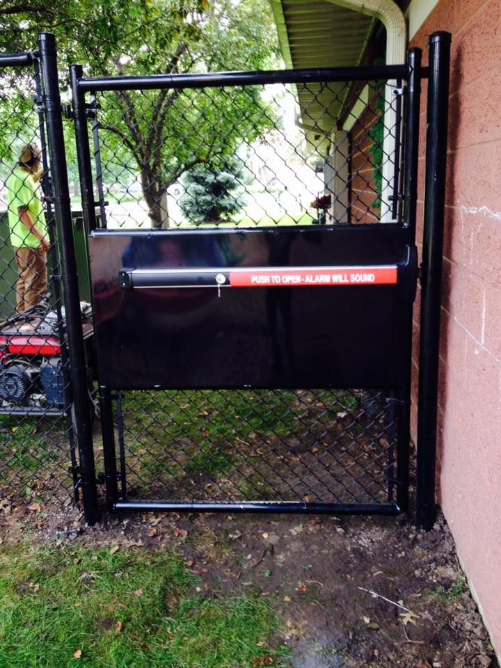 A black gate with a red sticker on it that says