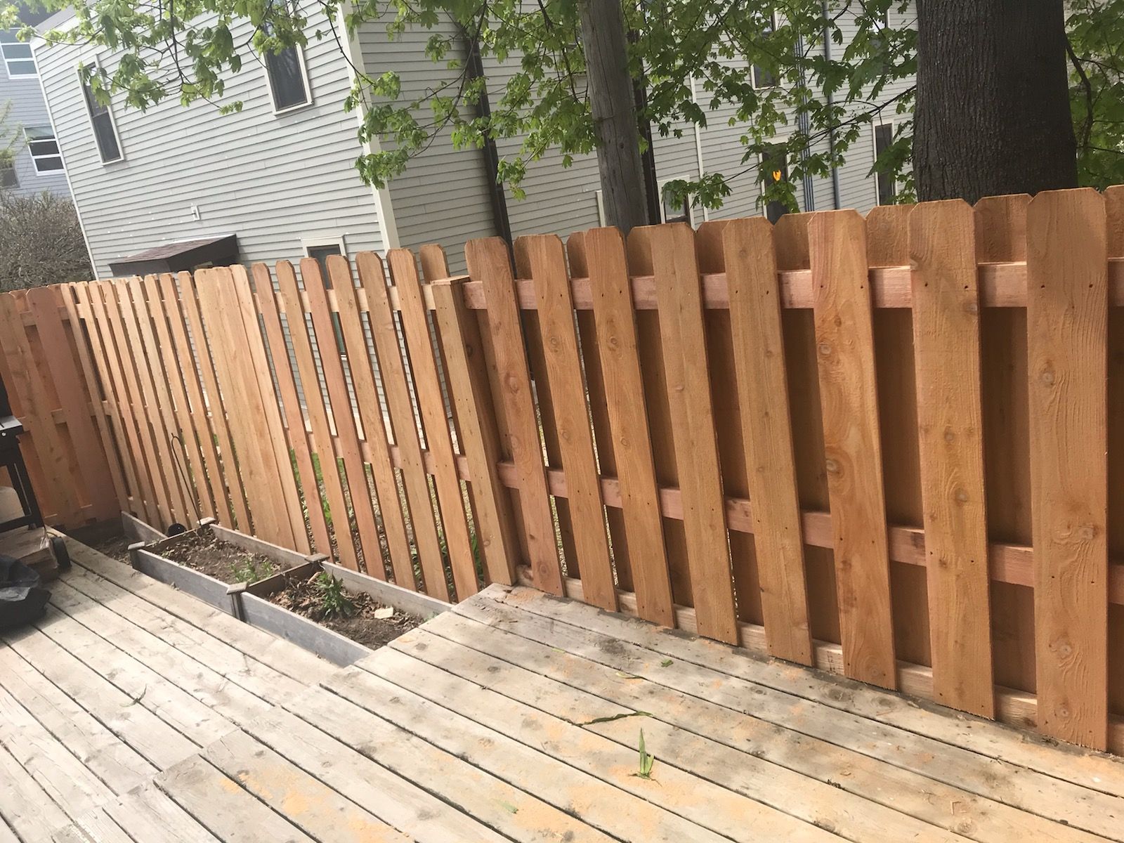 A wooden fence is sitting on top of a wooden deck.