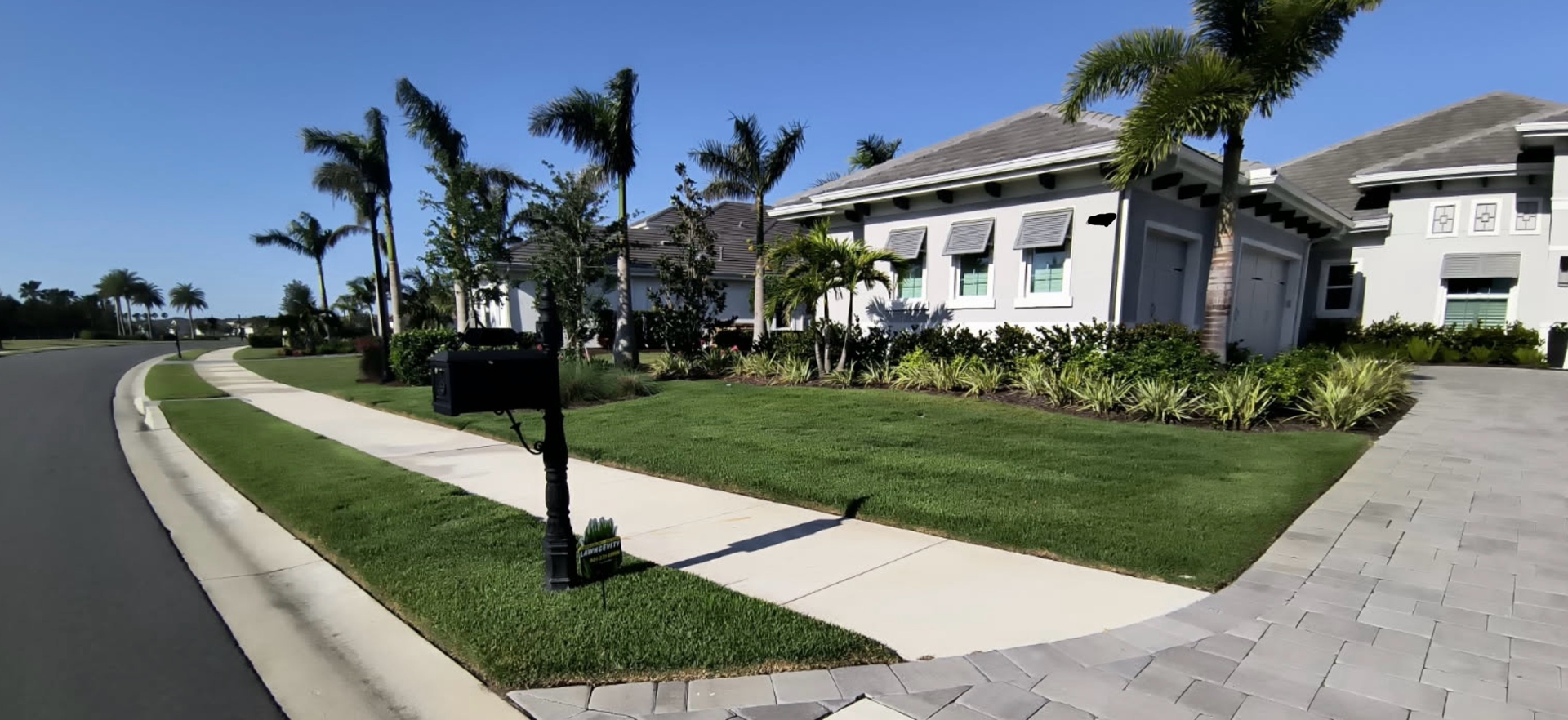 A house with a mailbox on the side of the road