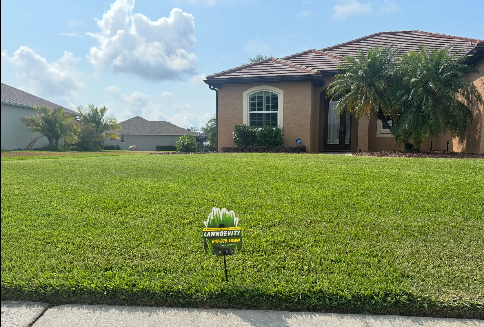 A house with a lush green lawn in front of it