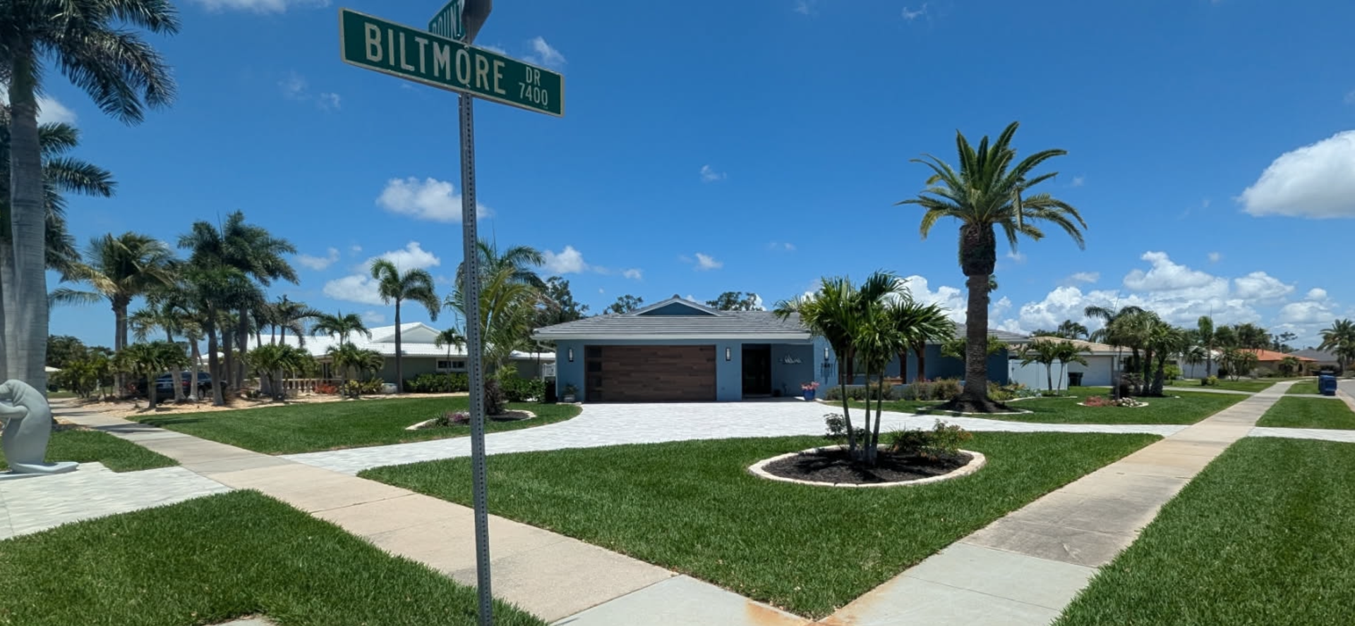 A residential area with a street sign that says Biltmore