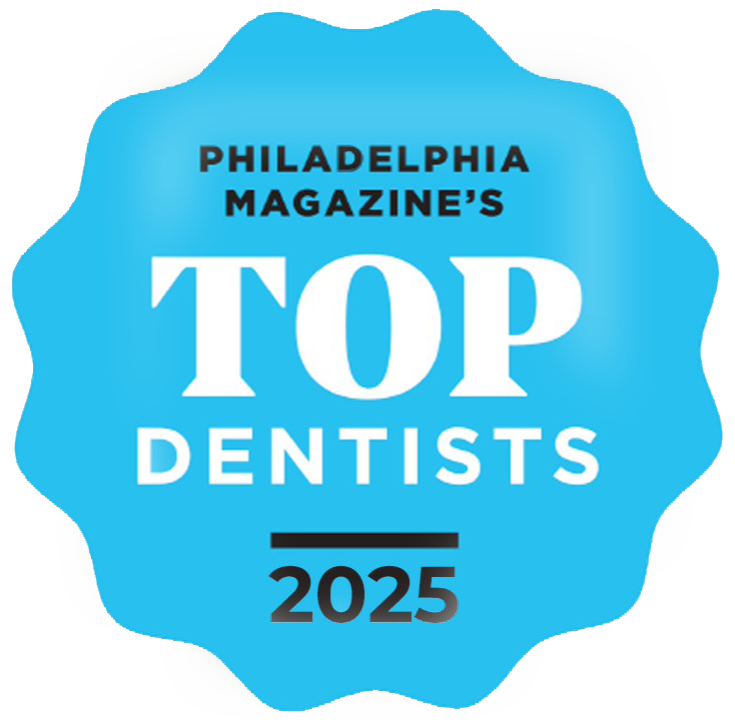 Blue badge: Philadelphia Magazine's Top Dentists. Text: TOP DENTISTS, 2025, with black bar beneath.