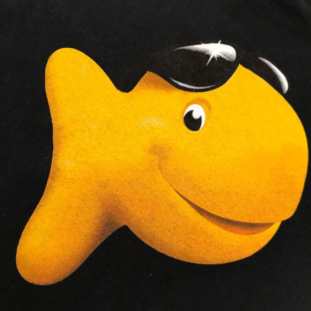 A yellow goldfish cracker wearing black sunglasses against a black background.