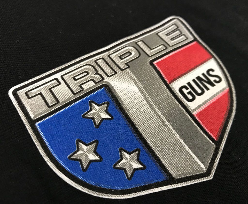 A shield-shaped embroidered patch reads 