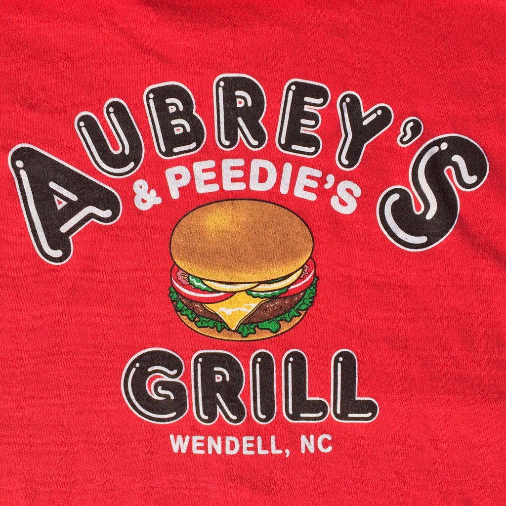 Logo for Aubrey's & Peedie's Grill in Wendell, NC, featuring a burger illustration on a red background.