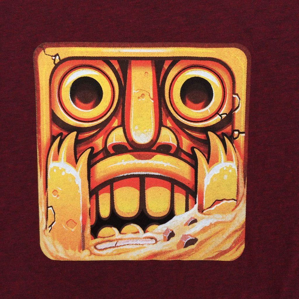 The gold-colored, square icon from Temple Run featuring a wide-eyed, stone idol face with jagged teeth.