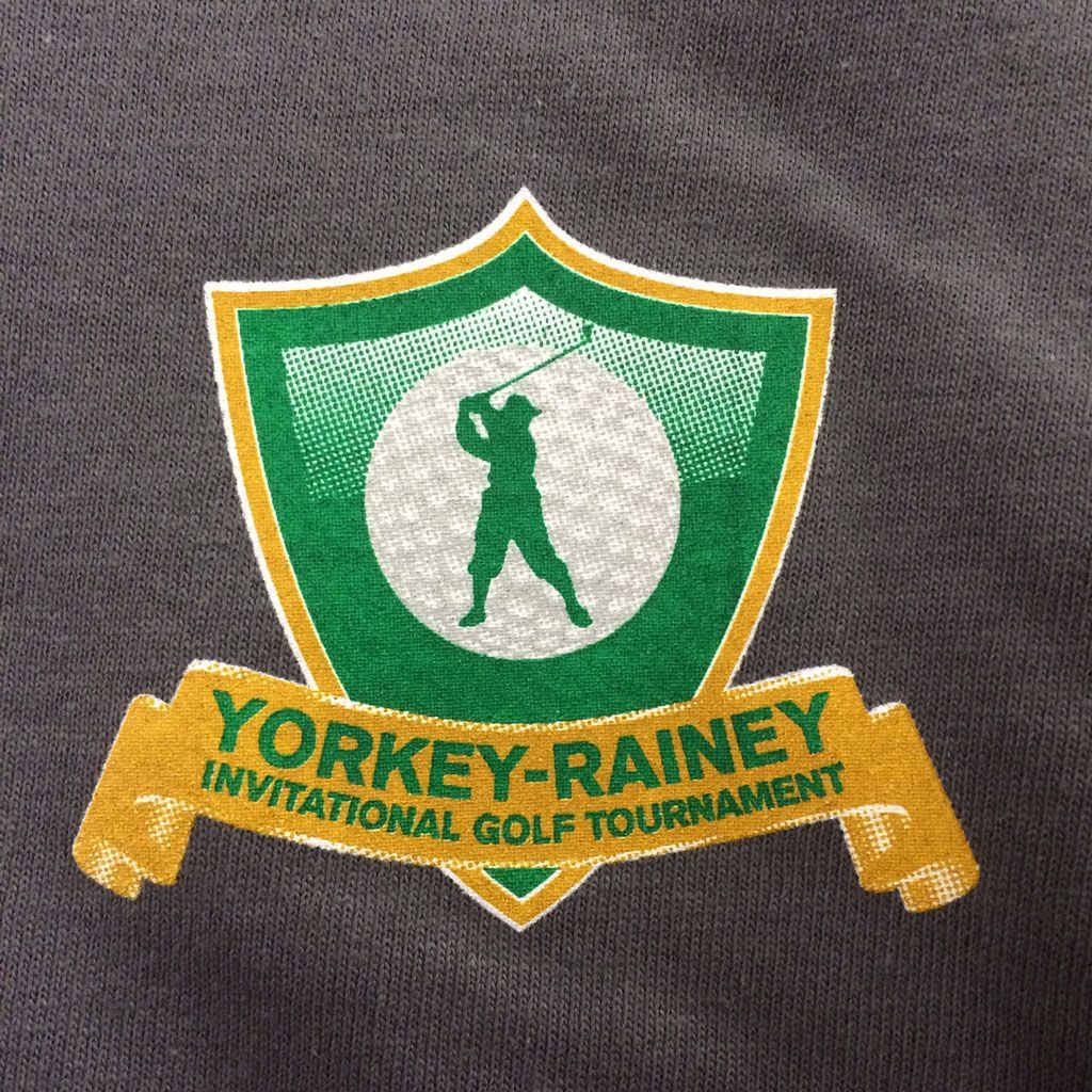 Embroidered logo of the Yorkey-Rainey Invitational Golf Tournament, featuring a golfer silhouette on a green shield.