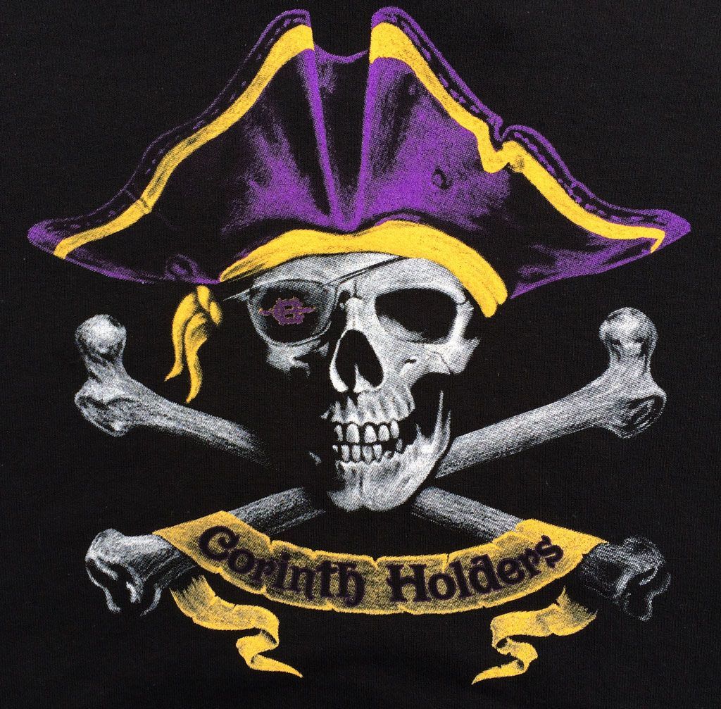 A skull wearing a purple and gold tricorn hat with an eyepatch, over crossed bones and a banner reading 