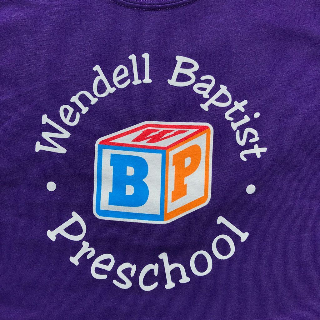 Logo for Wendell Baptist Preschool featuring a toy block with the letters W, B, and P on a purple background.
