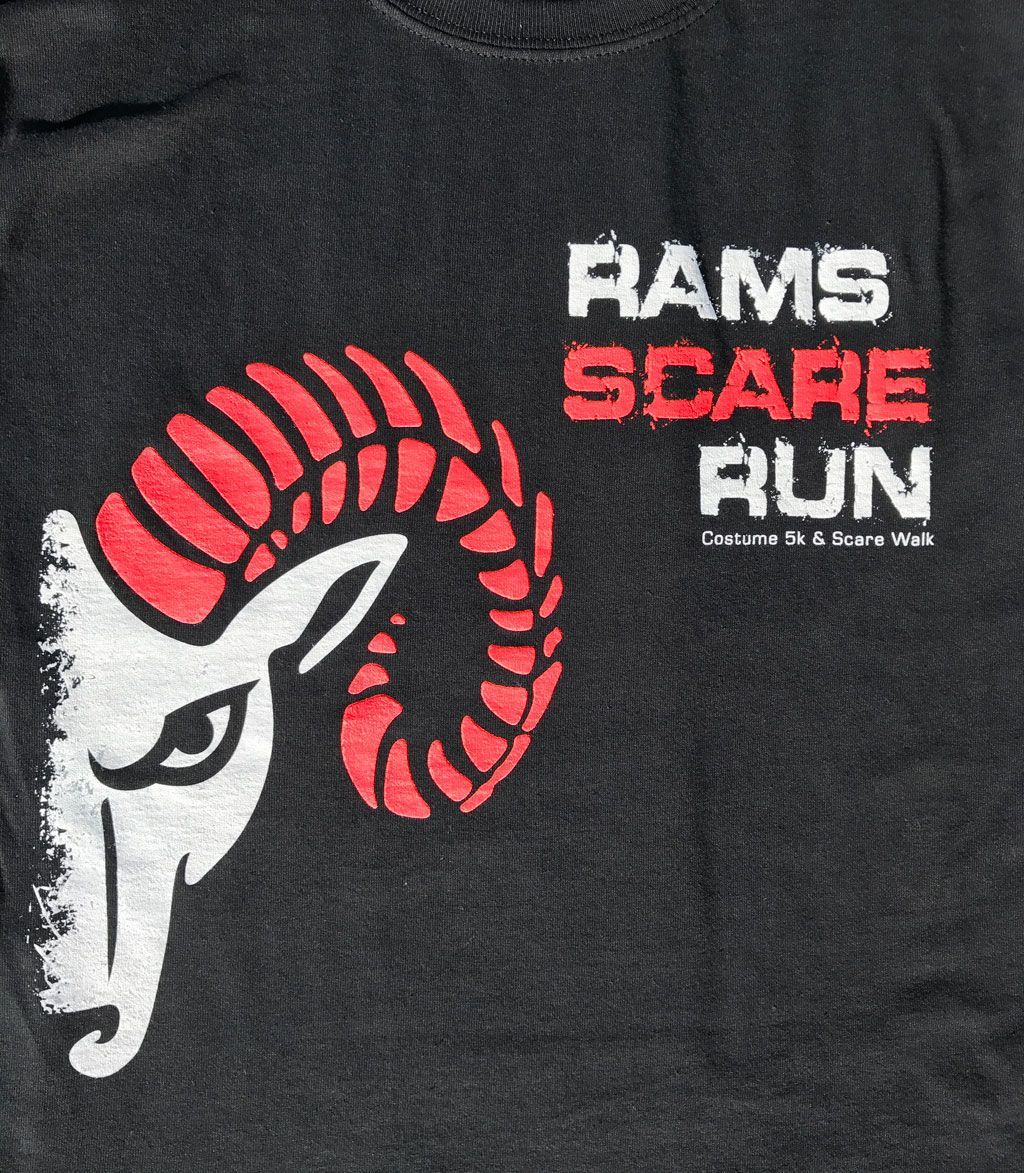 A graphic on a black shirt featuring a white ram head with large red horns, next to the white and red text 