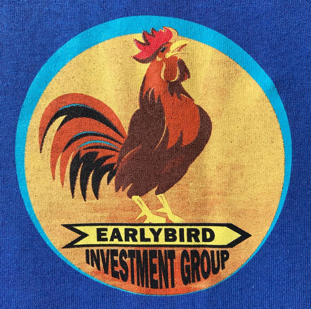 A circular logo featuring a colorful rooster on a gold background, with the text 
